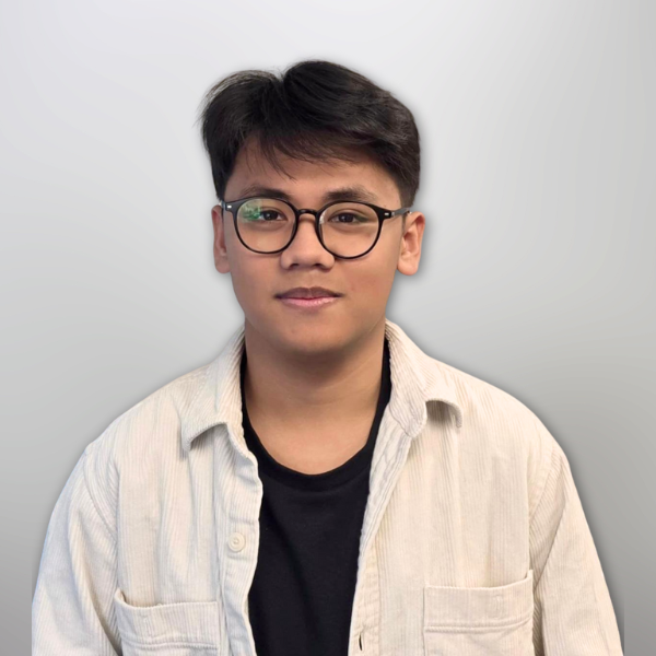 Potret Jerry Christian, anggota Biro Multimedia dan Media Cetak & Elektronik Majelis Daerah GPdI Australia, dengan tampilan kasual formal. Jerry mengenakan kemeja lengan panjang berwarna abu-abu terang yang terbuka sebagian pada bagian atas, memperlihatkan kaus hitam di dalamnya. Ia juga mengenakan kacamata bulat hitam yang menjadi ciri khasnya. Background gambar berwarna abu-abu keputihan dengan efek blur, menciptakan kesan bersih dan profesional. Foto ini menampilkan sisi milenial dari struktur pelayanan GPdI Australia yang aktif di bidang media dan produksi konten rohani digital.